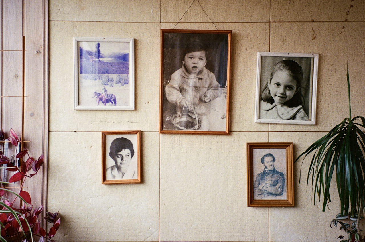 Zid s više uokvirenih obiteljskih fotografija različitih generacija
